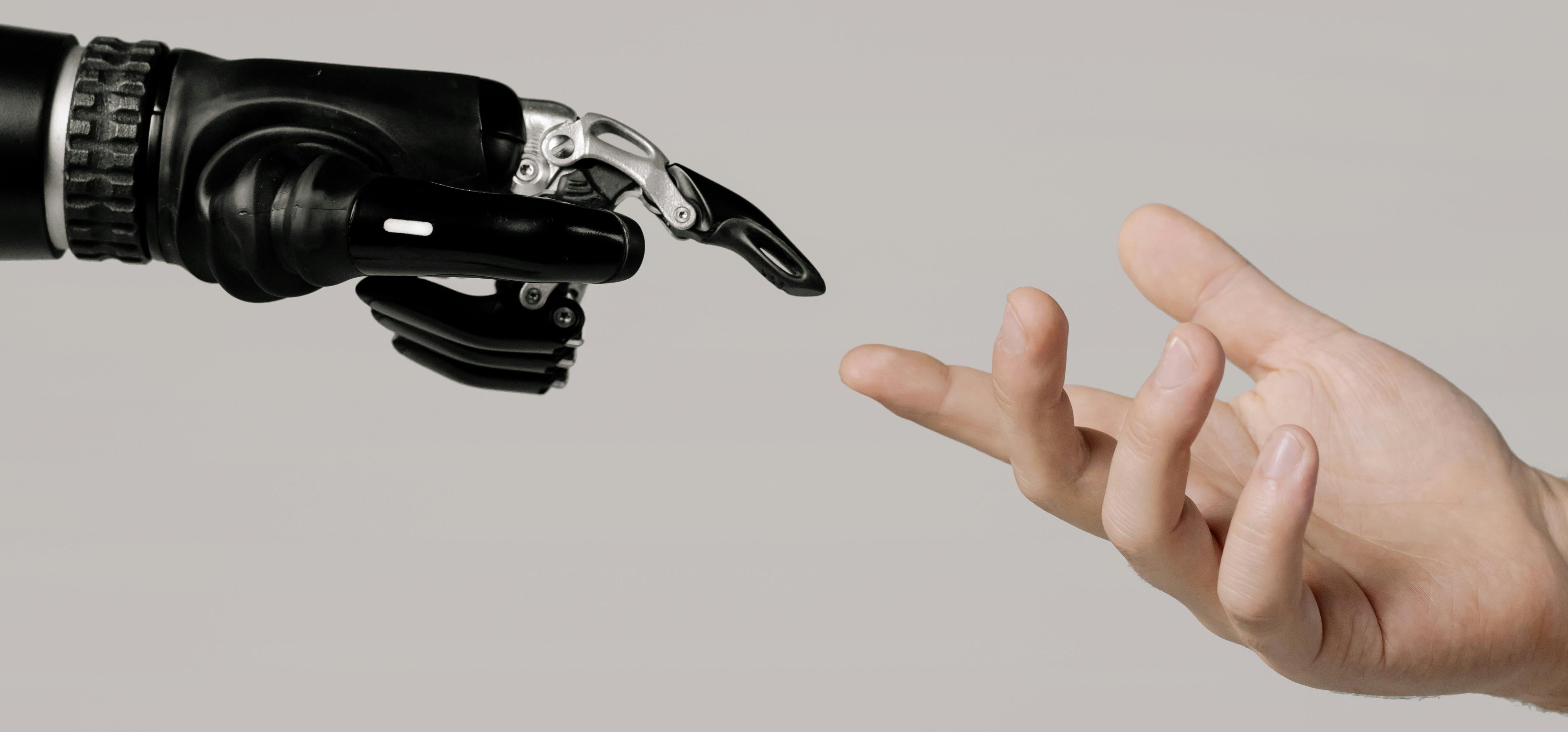 Robot hand reaching out to human hand