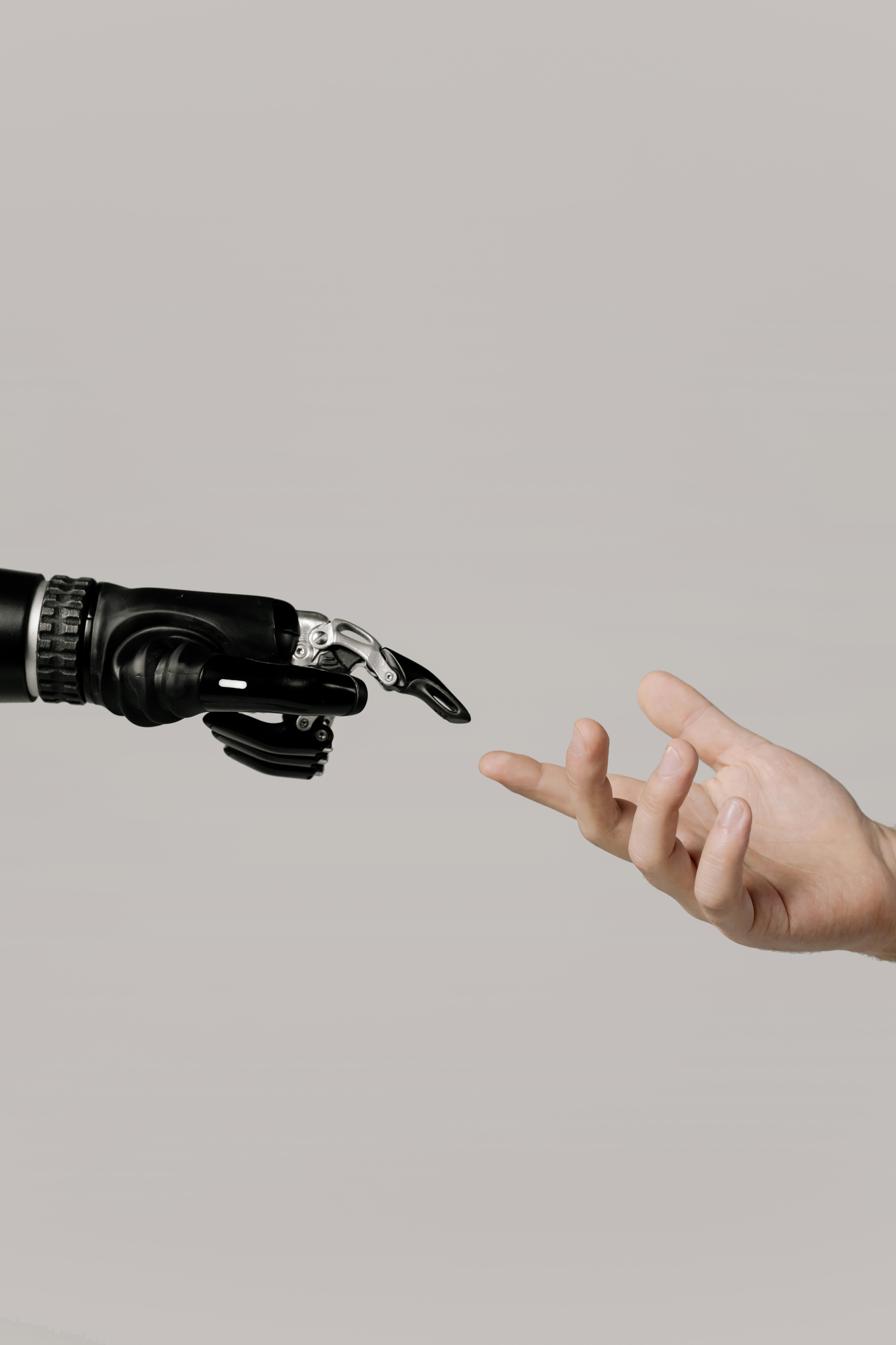 Robot hand reaching out to human hand